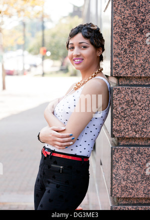Young African-American woman leaning on wall - USA Stock Photo