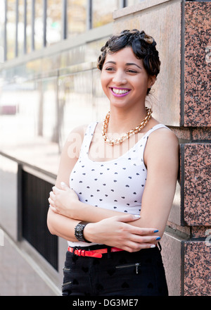 Young African-American woman leaning on wall - USA Stock Photo