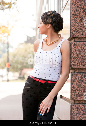 Young African-American woman leaning on wall - USA Stock Photo