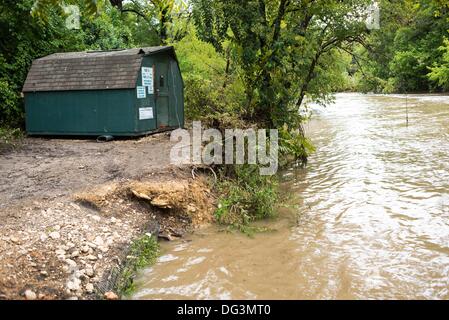 Austin, TX, USA. 13th Oct, 2013. A displaced canoe rental cabin is relocated downstream in Barton Creek, after bursting it's banks from 12 inches of rain fall. The creek is located near the Austin CIty Limits Festival, which was cancelled due to heavy rain fall in Austin, Texas (Credit Image: © Sandy Carson/ZUMAPRESS.com) Credit:  ZUMA Press, Inc./Alamy Live News Stock Photo