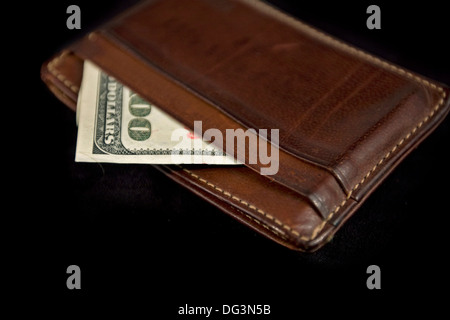 wallet with hundred dollars bill on black background Stock Photo