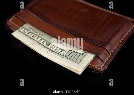 wallet with hundred dollars bill on black background Stock Photo