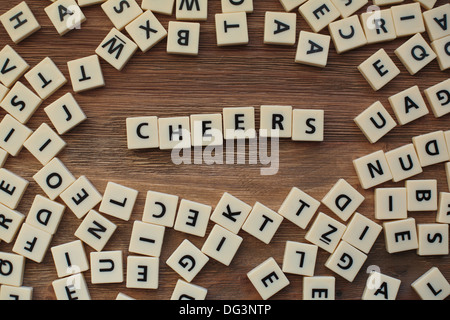 Plastic letters from a childrens' spelling game on a wooden table spell words Stock Photo