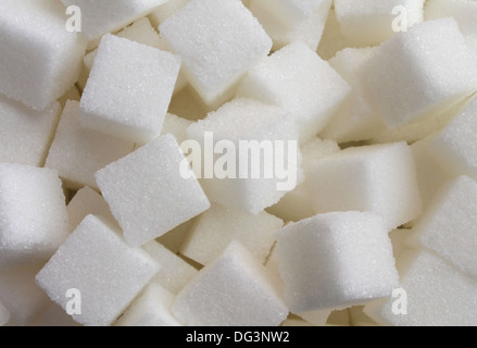 Sugar cube food ingredient background with a close up of a pile of sweet white lumps of cubes as a symbol of cooking and baking Stock Photo