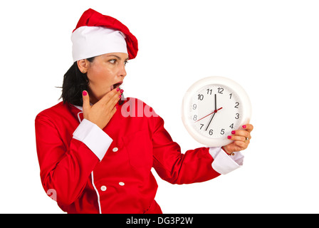 Scared chef woman looking at clock isolated on white background Stock Photo