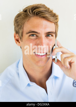 Young Handsome Attractive Business Man Smiling Talking on Smart Phone Stock Photo