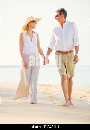 Happy Romantic Middle Aged Couple Enjoying Walk on the Beach Stock Photo