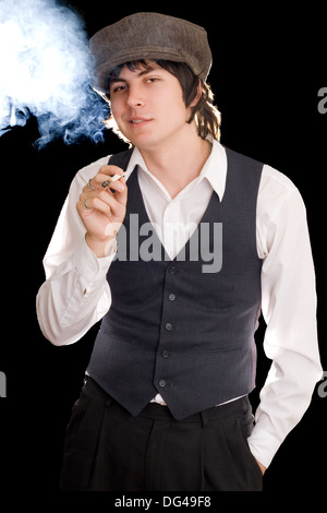 Young man smoking and making faces. Isolated on black Stock Photo