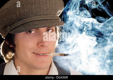 Portrait of smoking man with sly smile. Isolated on black Stock Photo