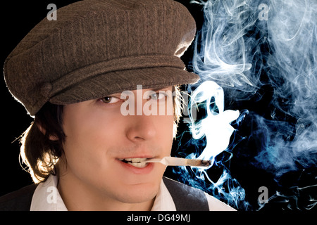 Portrait of smoking man with cunning smile. Isolated on black Stock Photo