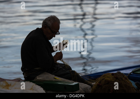 Old hands, Dexterity, mending nets, fishing net, repairing nets Stock Photo