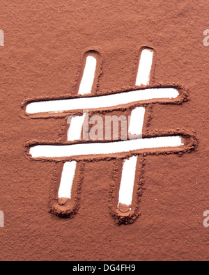 Hash mark drawn on pure cocoa powder Stock Photo