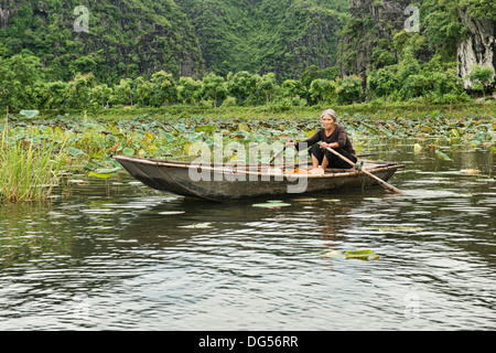 paddling on the Tam Coc River in Ninh Binh, Vietnam Stock Photo