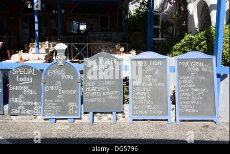 SANTORINI (THIRA), CYCLADES, GREECE. Chalkboard menus outside a taverna in the resort of Kamari. 2013. Stock Photo