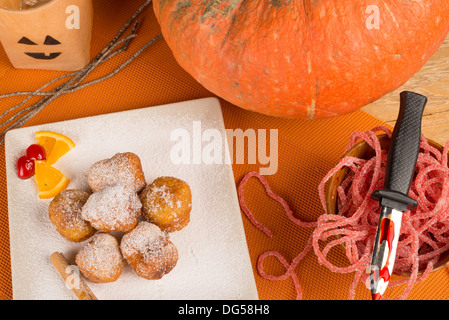 A traditional sweet Halloween dessert served with holiday decoration. Stock Photo