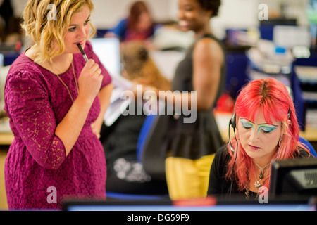 Telephone operators for the clearing helpline at the University of the West of England (UWE Bristol) take calls from hopeful stu Stock Photo