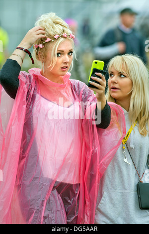 The Reading Festival - a music fan adjusts her hair while heading for the main stage Aug 2013 Stock Photo