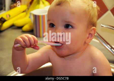 A baby boy brushing his teeth Stock Photo