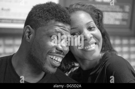 A man and woman happily pose while working at a store in Chicago. Stock Photo