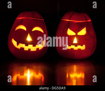 Two Halloween pumpkin lanterns lighting up the dark. Stock Photo
