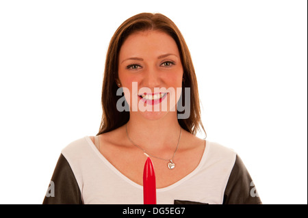 Young brunette with happy face holding red candle in her hands and looking into the camera Stock Photo