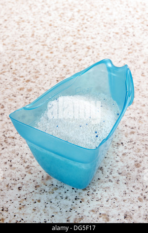 Blue plastic washing powder measuring cup isolated on white Stock Photo -  Alamy