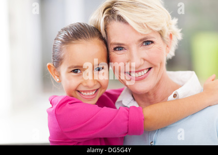 beautiful young girl hugging her senior grandmother Stock Photo