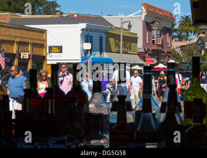 Sightseers strolling down Bridgeway in Sausalito, California as seen through the window of a bar. Stock Photo