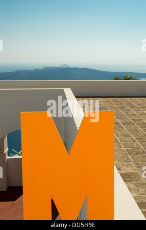 Big M letter on the roof of a house in Santorini with Aegean Sea in the background, Greece 2013. Stock Photo