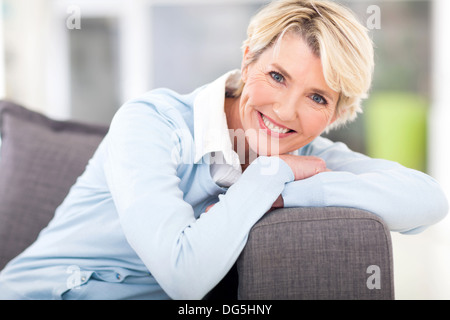 pretty senior woman relaxing on a couch at home Stock Photo