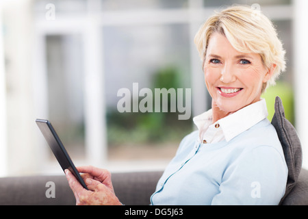 elegant middle aged woman using tablet pc at home Stock Photo