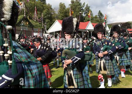 Village of Braemar, Scotland. The massed pipe bands marching at the Royal Braemar Gathering games. Stock Photo