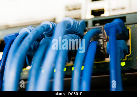 Network cables in switch and firewall in cloud computing data center server rack Stock Photo
