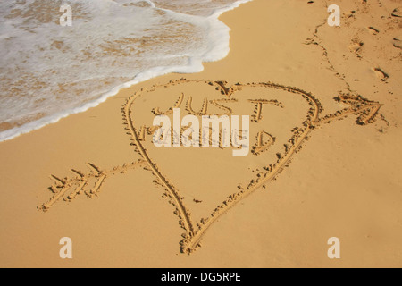 'Just married' written in sand on a beach Stock Photo