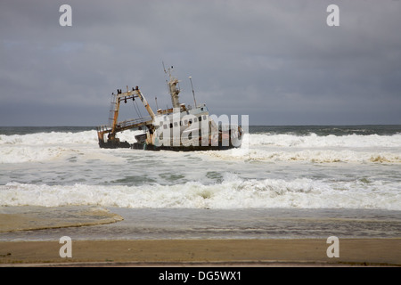 Fishing ship in danger on the beach in Swakopmund namibia Stock