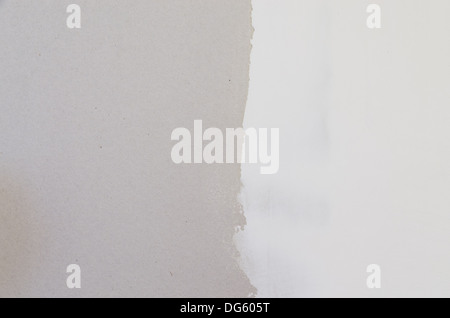 drywall with half covered with joint compound spackle background Stock Photo