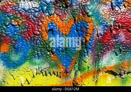 mottled spray painted background with dripping texture and orange heart Stock Photo