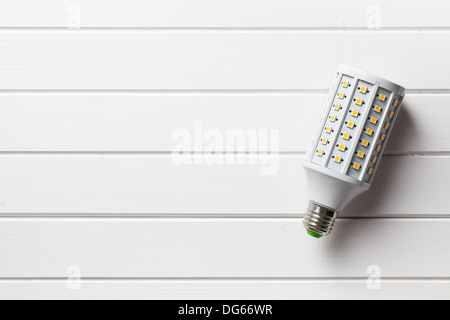 top view of LED light bulb on white wooden background Stock Photo