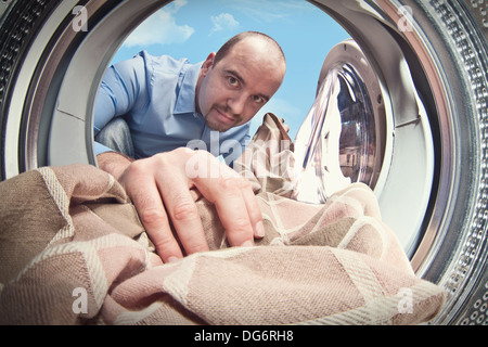 man load his washing machine Stock Photo