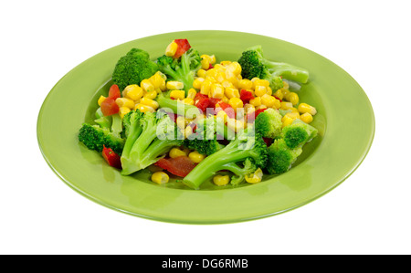 A serving of cooked broccoli, corn and red peppers on a green plate. Stock Photo