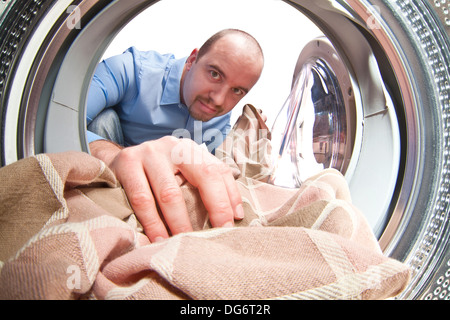 man load his washing machine Stock Photo
