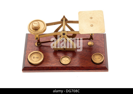 Brass and wood scales and small weights in ounces on a white background, with 'made in England' stamped on the scales Stock Photo