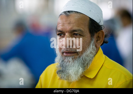 Man of Middle Eastern ethnicity, working in a fish market in Abu Dhabi Stock Photo