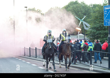 London, UK. 15th October 2013. Police ride away from flares outside Wembley Park station before the England vs Poland match at Wembley stadium, London, 15/10/2013. Credit:  Luca Marino/Alamy Live News Stock Photo