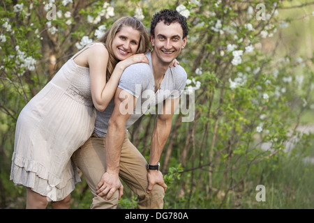 Young pregnant couple outdoors in spring Stock Photo