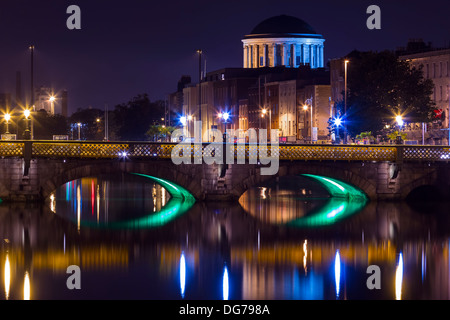 Dublin, Ireland - October 14, 2013: The historic building of Four Courts in the opposite side of River Liffey in the centre of D Stock Photo