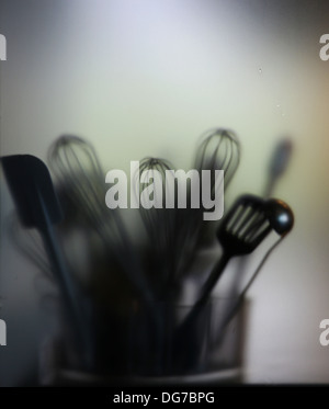 Kitchen tools. blade, brush, skimmer, trough blurry glass Stock Photo