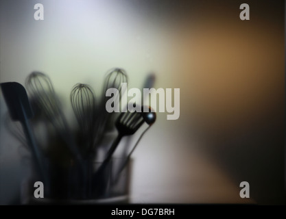 Kitchen tools. blade, brush, skimmer, trough blurry glass Stock Photo