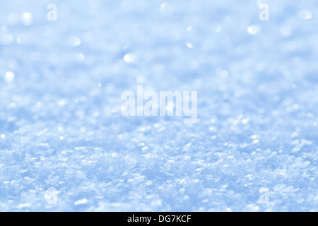 Blue sparkling snow background with white little snowflakes. Stock Photo
