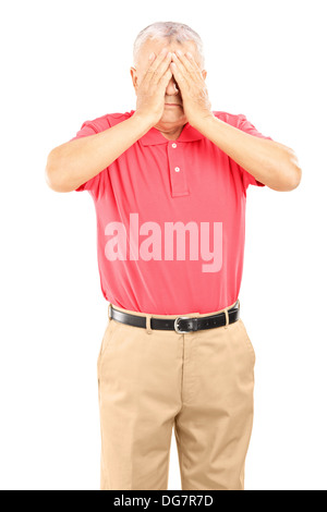 Mature man with hands over his eyes Stock Photo